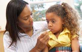 Mother taking daughter's temperature