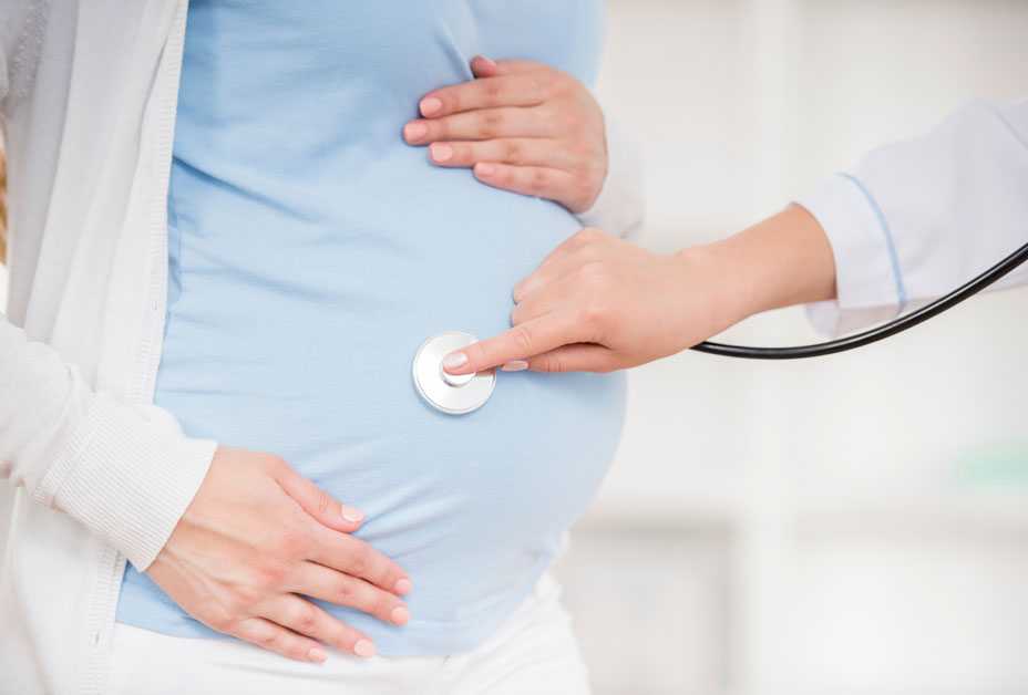 Pregnant woman being examined by doctor