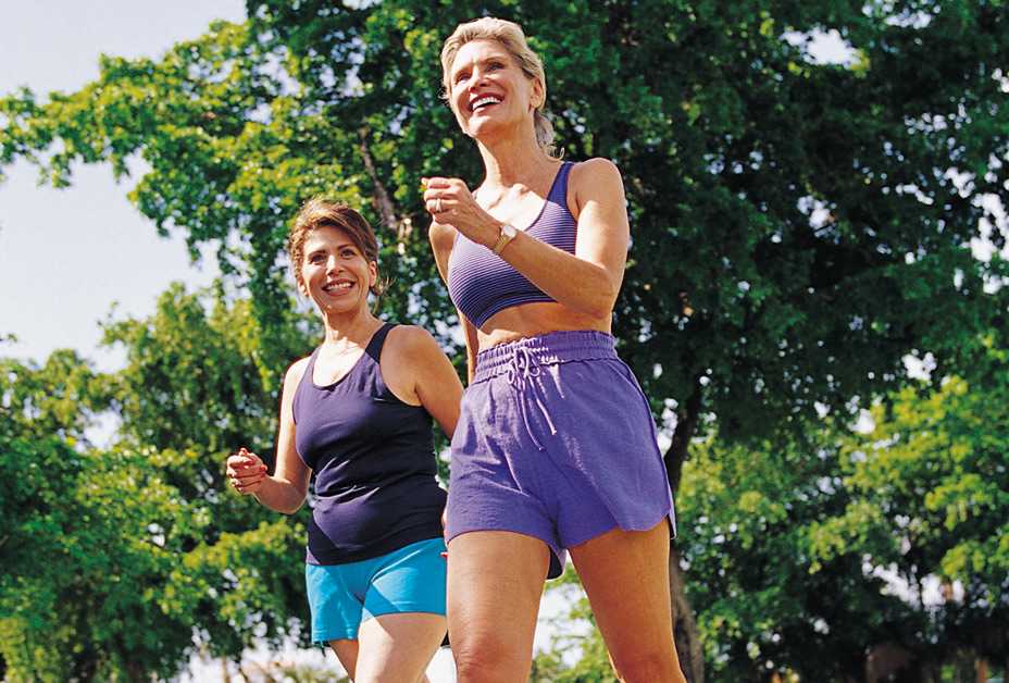 Two women power walking