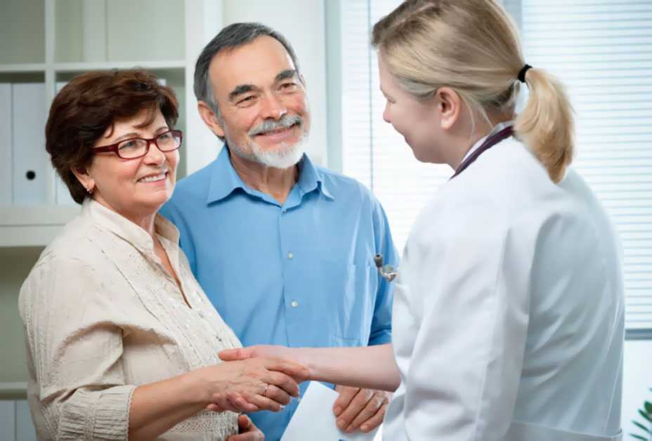 Husband and wife talking to doctor