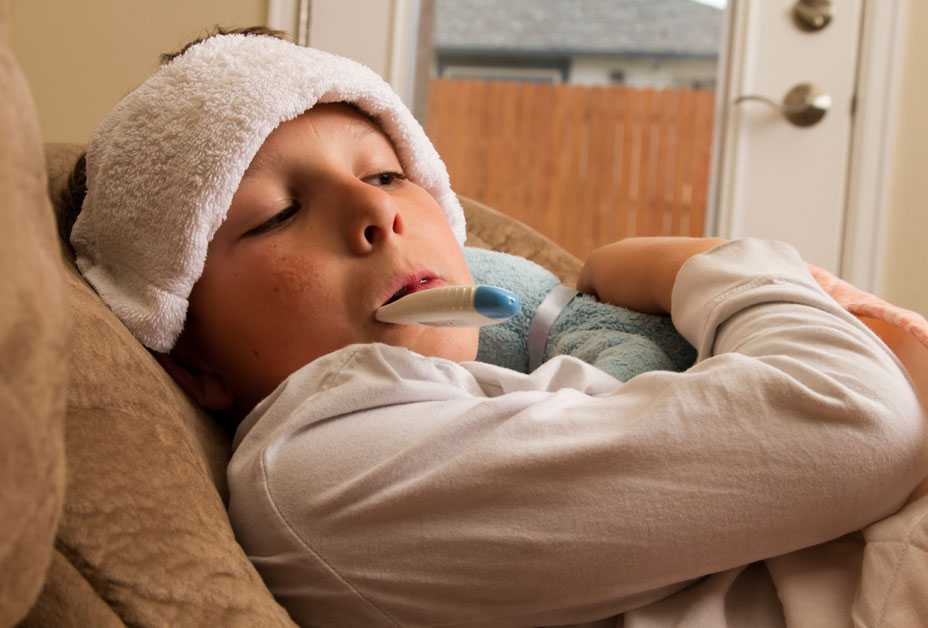 Boy having his temperature taken