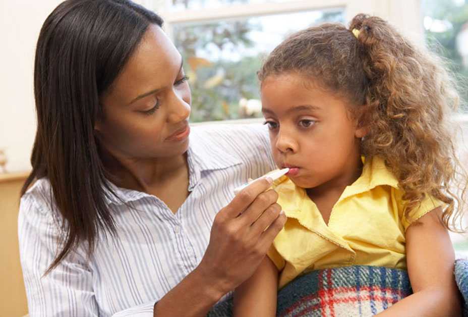 Mother checking daughter's temperature