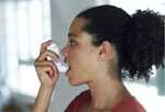 Woman using inhaler