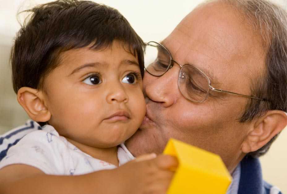 Grandfather kissing grandson