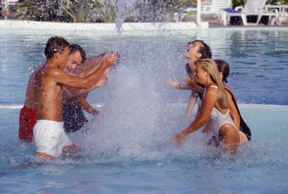 Children playing in water fountain