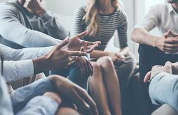 Photo: group of people sitting in a circle talking