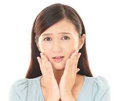 Female patient with her hands on her face