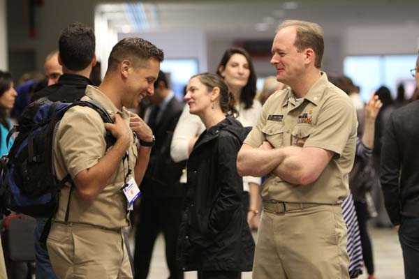 Conference attendees network between sessions