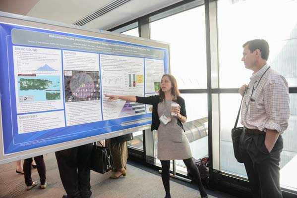 EIS officer, Rachel Burke, discusses Zika work during poster symposium