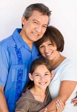 Mother, father and daughter smiling