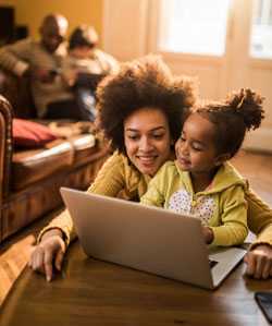 Mother and daughter using laptop