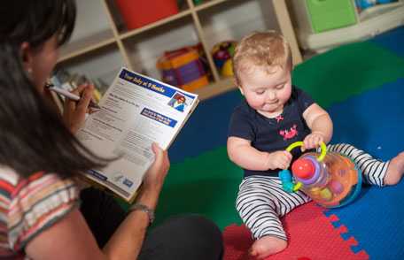 Mother with baby, reviewing checklist