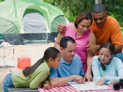 Family camping and looking at map