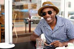 Man sitting at table and checking smartphone