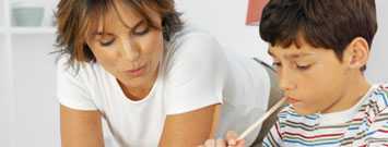  Photo: Mother helping son with homework