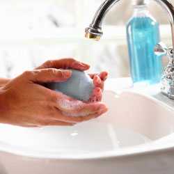 Woman washing hands with soap