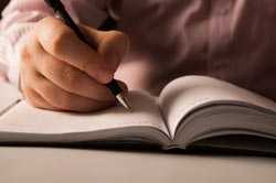 Man writing in journal