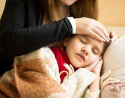 Mother comforting sick child