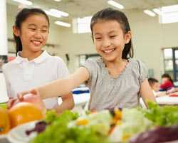 Two girls at salad bar