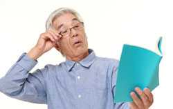 Man with arms outstretched trying to read a book