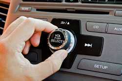 Hand turning up volume knob