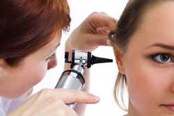 Woman getting ear exam