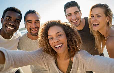 Group of young adults taking selfie