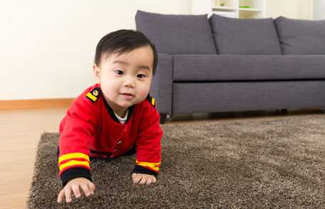 Baby crawling across floor