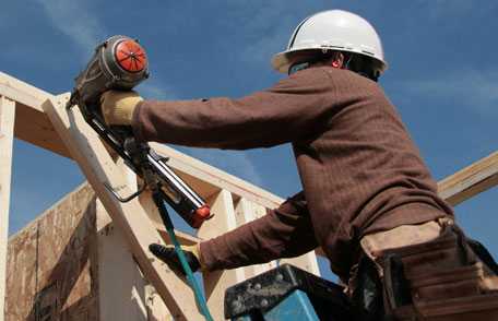 Worker using nailgun