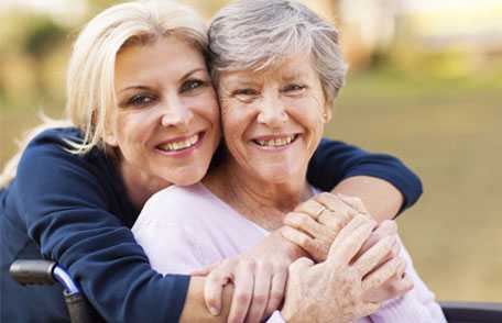 Adult woman hugging mother's neck