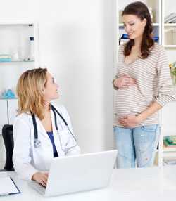 Pregnant woman sharing information about her job with her doctor.