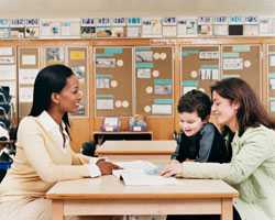 Teacher meeting with student and mother