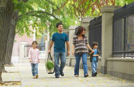 Family walking on sidewalk