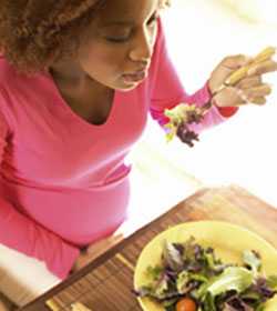 Photo: A pregnant woman eating.