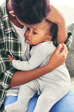 Young boy holding baby