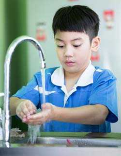 Boy washing his hands