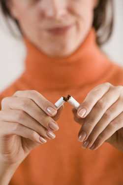 Woman breaking cigarette in two