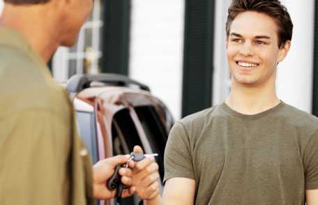 Teenage driver taking keys from parent