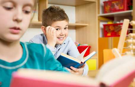 Young boy reading a book