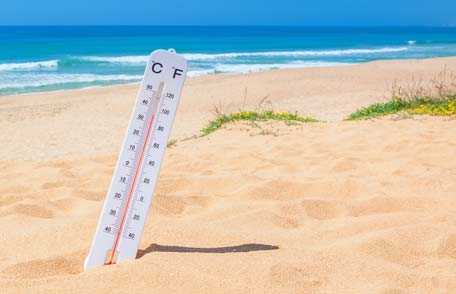 Thermometer in sand on beach