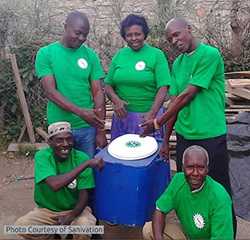 Sanivation team showcasing a portable toilet.