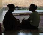 Women chatting in doorway of health clinic.