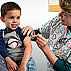 Take time to get a flu vaccine like this young boy from an older female nurse.