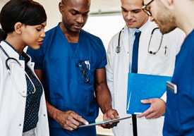 Photo: health care professionals discussing a patient's chart