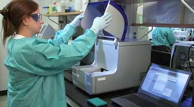 Photo: Lab technician using equipment to conduct advanced molecular detection tests to improve flu vaccines