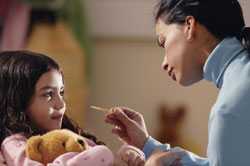 Mother taking daughter's temperature