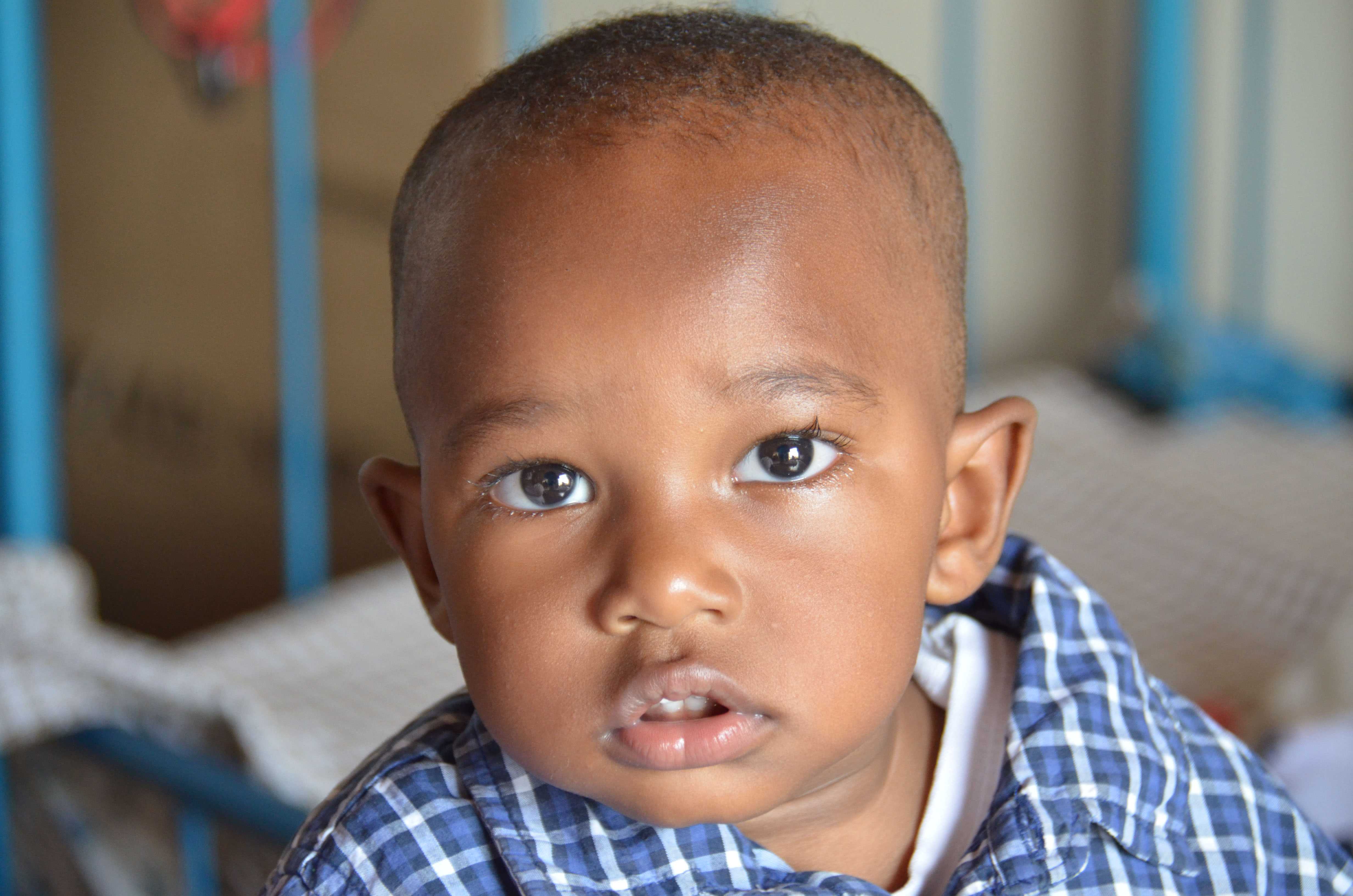 A young boy waits in the PMTCT clinic with his mother.