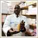 man holding medicine packet in supply room