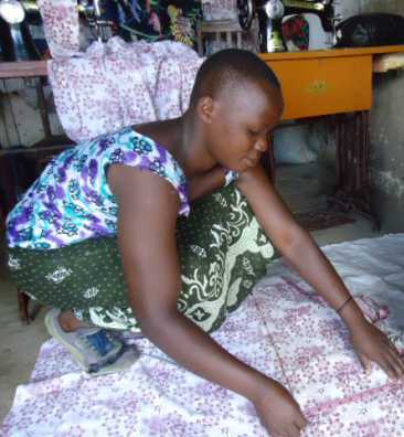 Rukia at work in her tailoring shop.