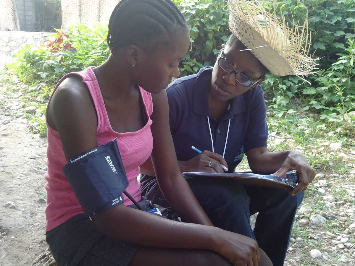 FETP Haiti resident M.J. Laraque follows up with a questionnaire after taking the participant’s blood pressure on May 14, 2013. A KAP study was performed in the urban area of Ennery in May 2013 to determine the prevalence of arterial hypertension. The 3 main activities of the study included a KAP interview, blood pressure recording, as well as the measurement of participants’ height and weight. Submitted by Apollon Destine Miracle--Haiti.